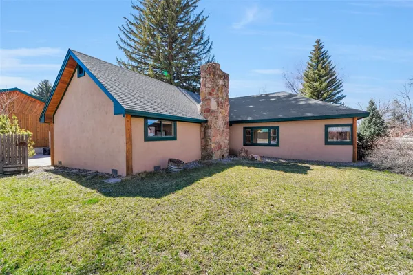 a backyard of a house with outdoor seating