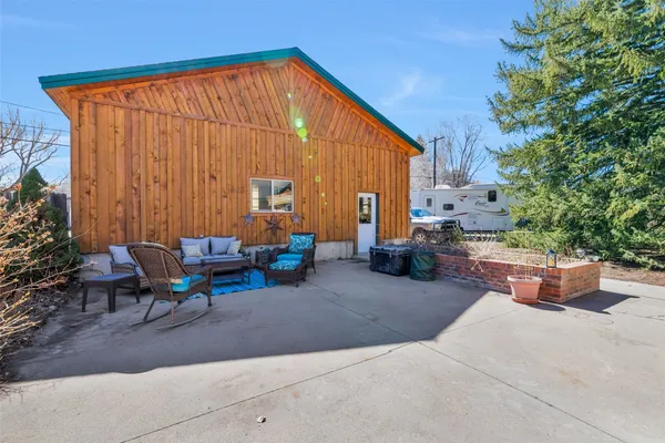 a outdoor living room with furniture and a fireplace