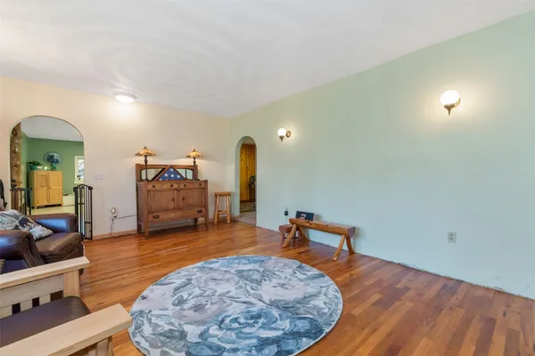 a view of a room with gym equipment and wooden floor