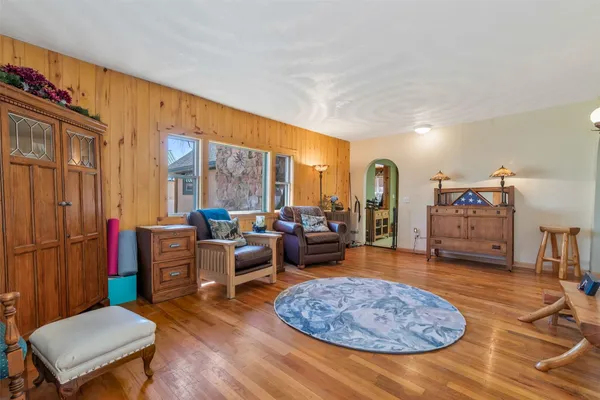 a living room with furniture a rug and a large window