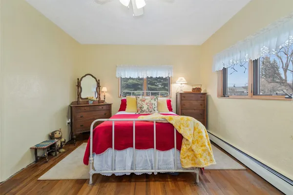 a bed sitting in a bedroom next to a window