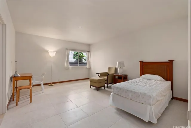 a bedroom with a bed and a chair