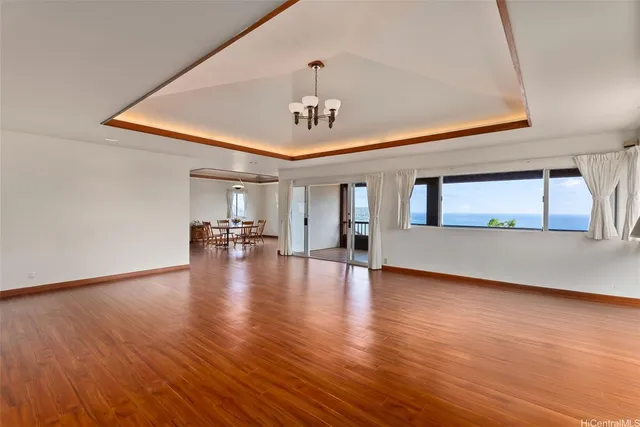 a view of livingroom with hardwood floor and kitchen view