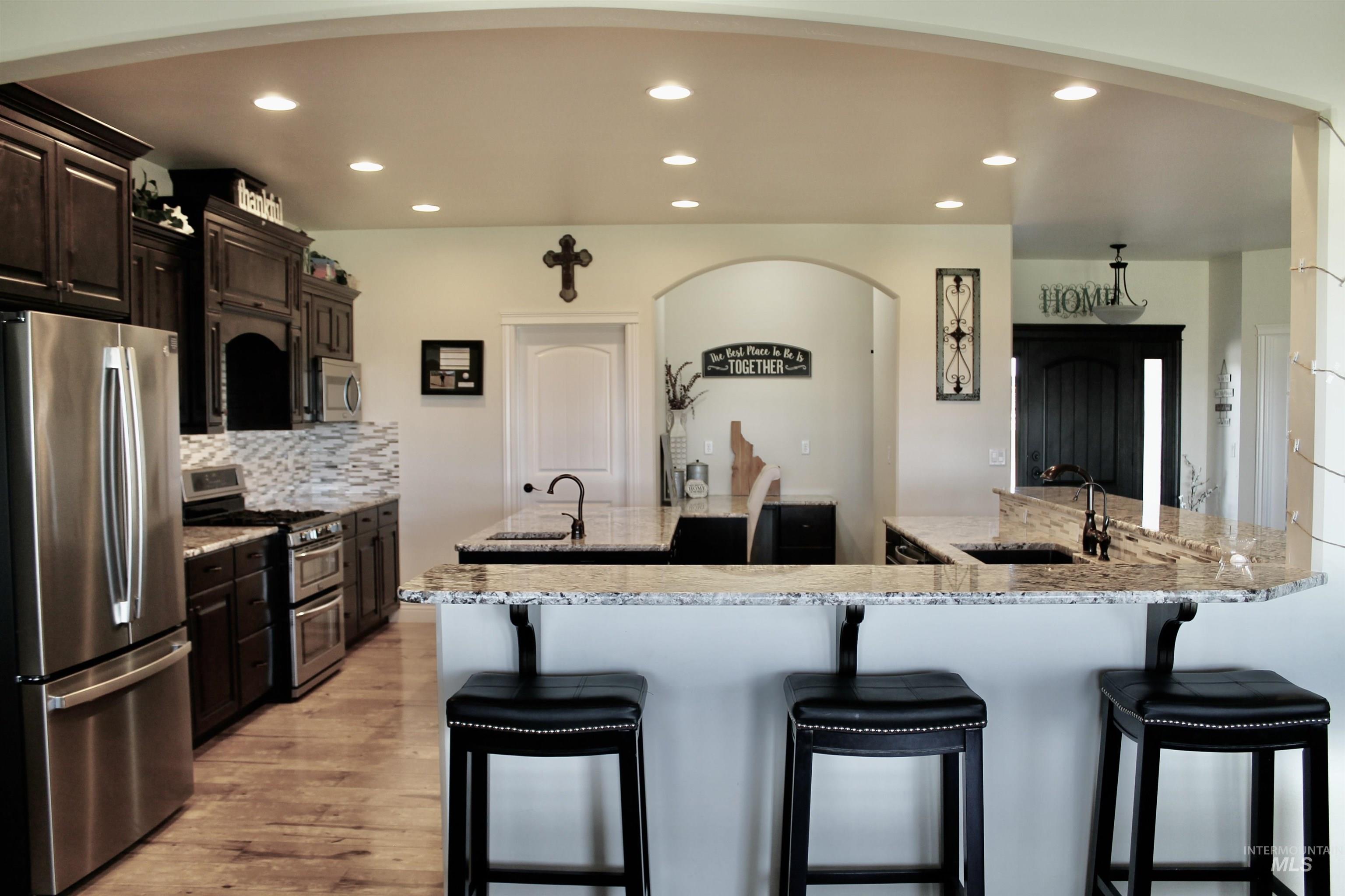 2464 Windmill Drive Twin Falls, ID 83301 - Photo 13 of 47 Kitchen with appliances with stainless steel finishes, recessed lighting, a breakfast bar, a large island with sink.