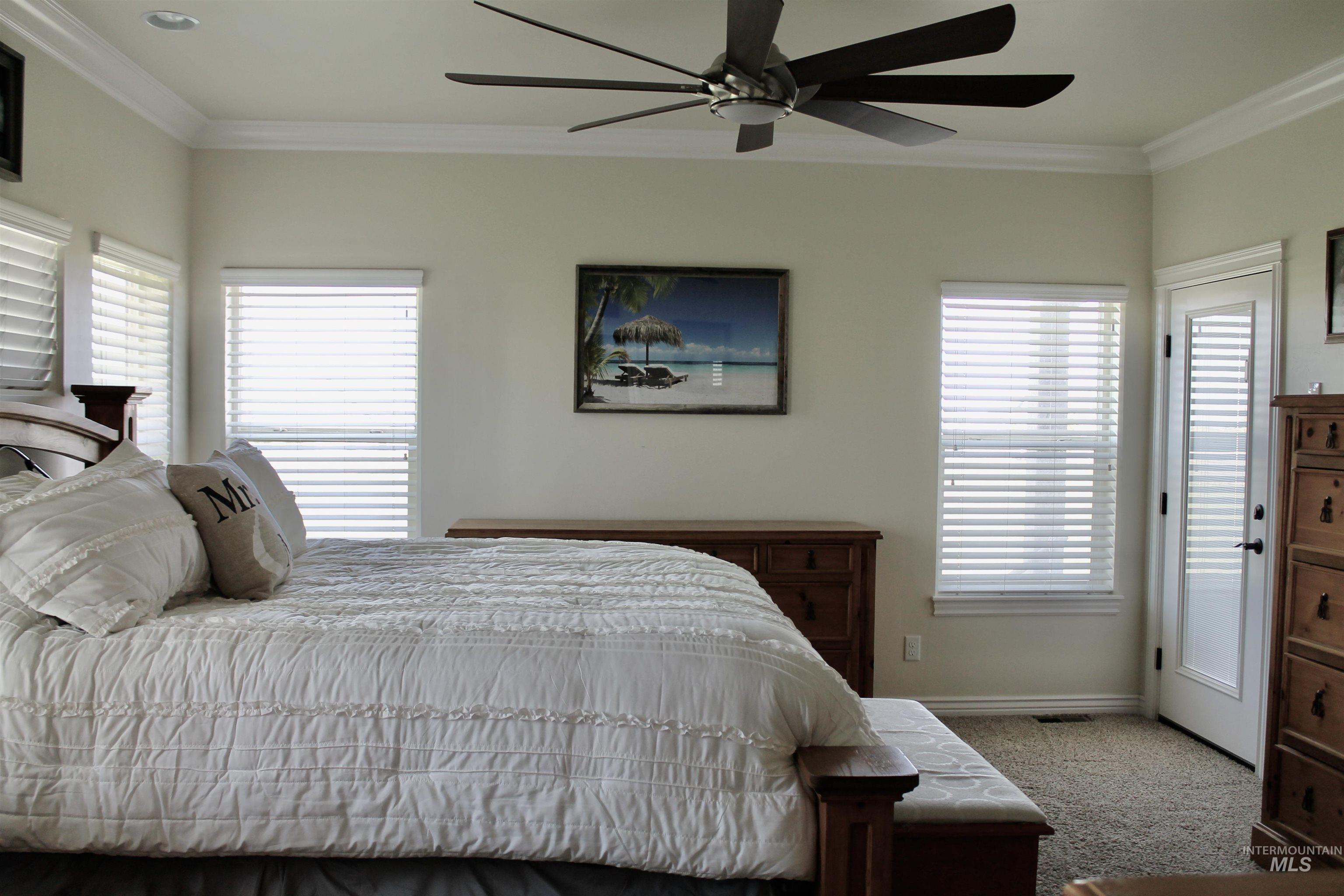 2464 Windmill Drive Twin Falls, ID 83301 - Photo 40 of 47 Carpeted bedroom featuring ornamental molding, multiple windows, and a ceiling fan