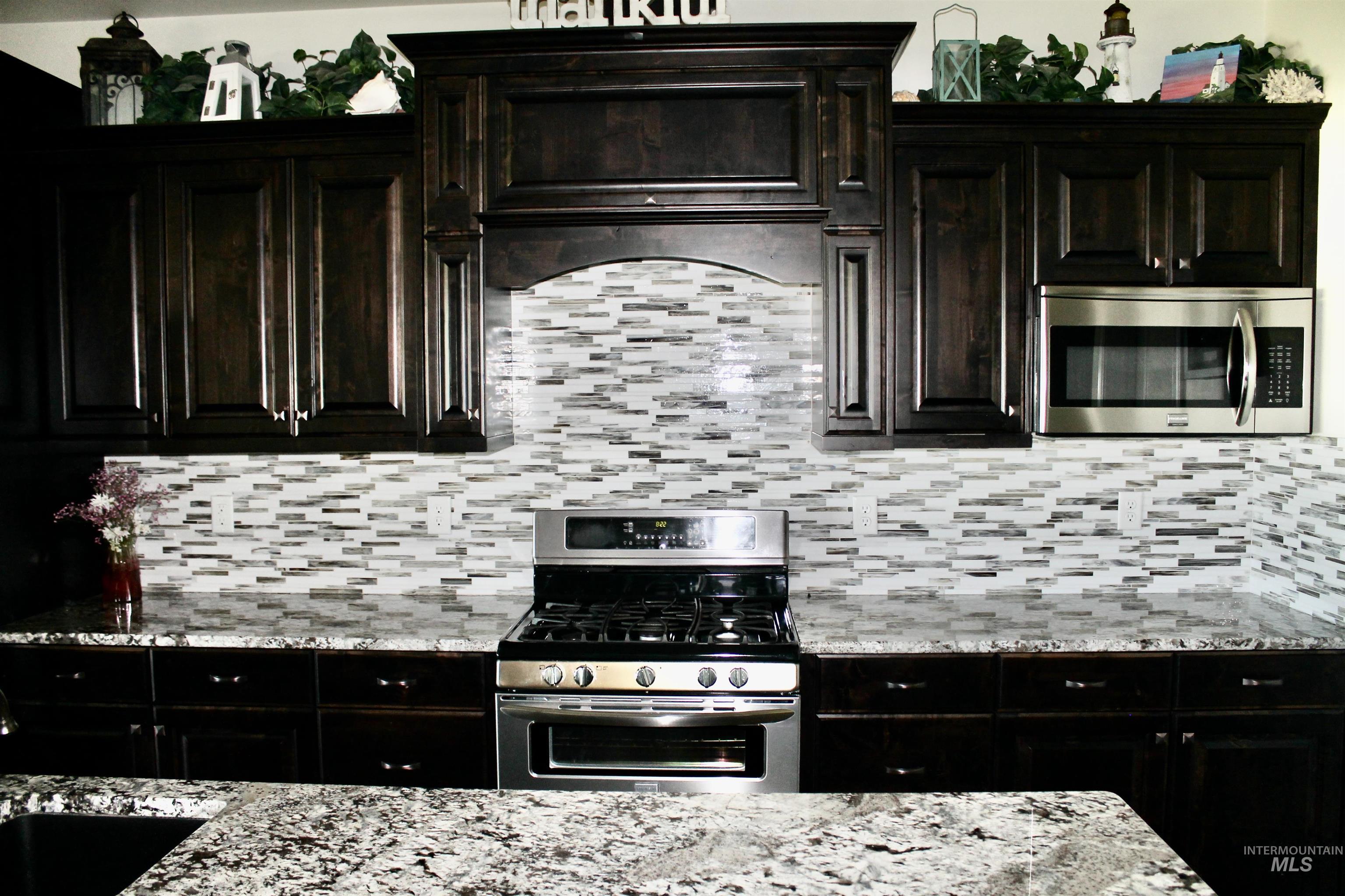 2464 Windmill Drive Twin Falls, ID 83301 - Photo 8 of 47 Kitchen with stainless steel appliances, tasteful backsplash, granite counter tops, and exhaust hood