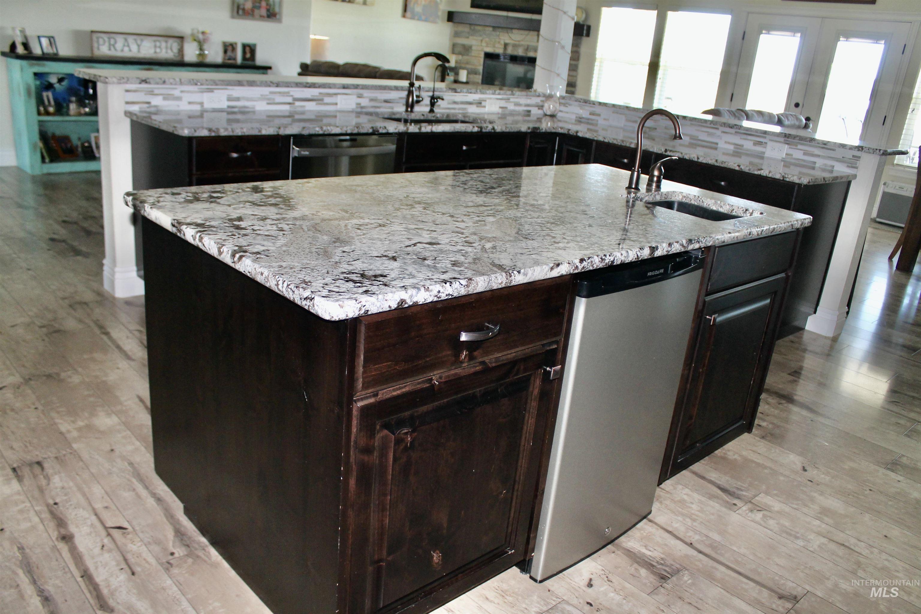 2464 Windmill Drive Twin Falls, ID 83301 - Photo 9 of 47 Kitchen with large island with sink, dishwasher, and granite countertops