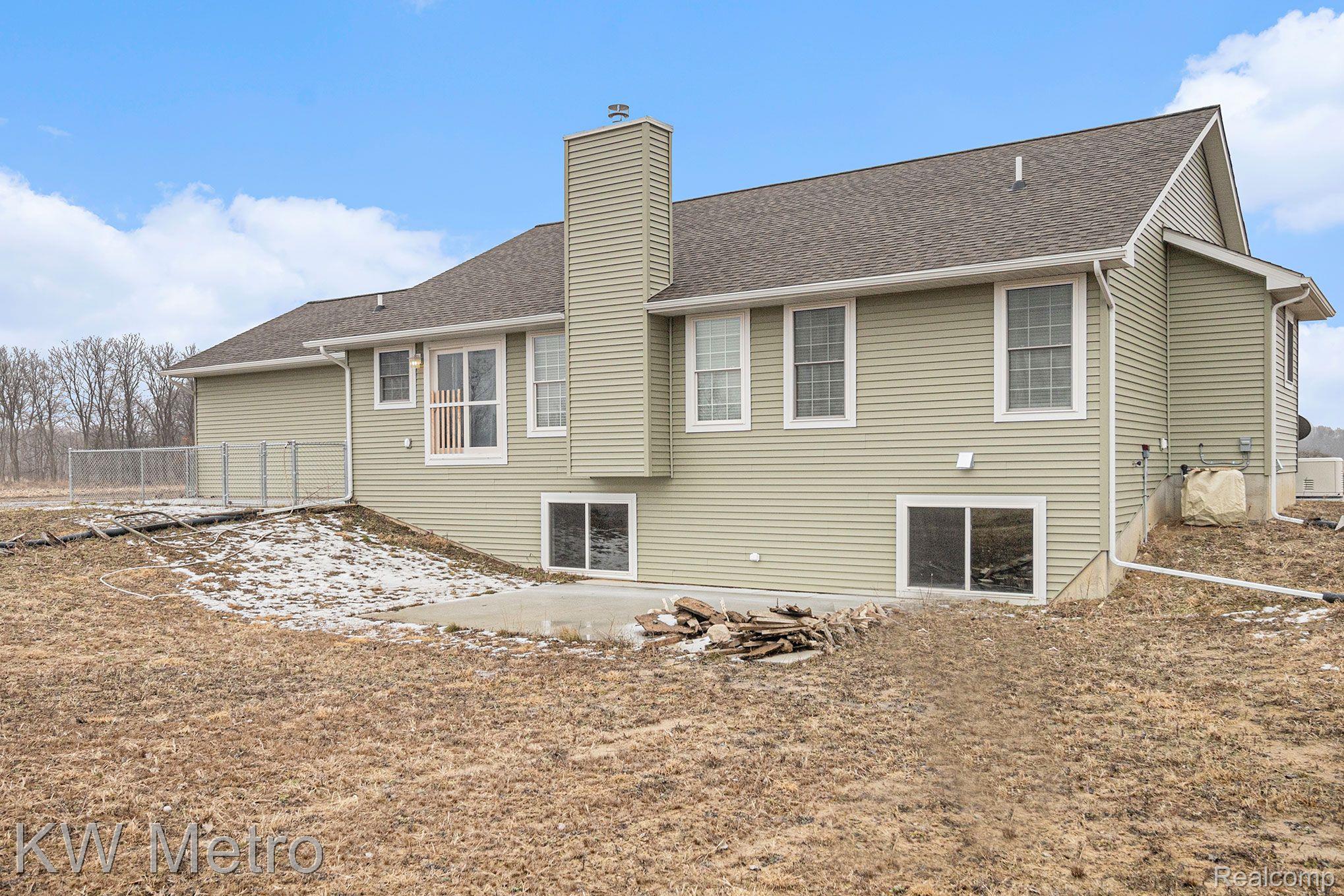 3644 Gannon Road Fowlerville, MI 48836 - Photo 24 of 33 Rear of House, 2 Egress Windows and Dog Run