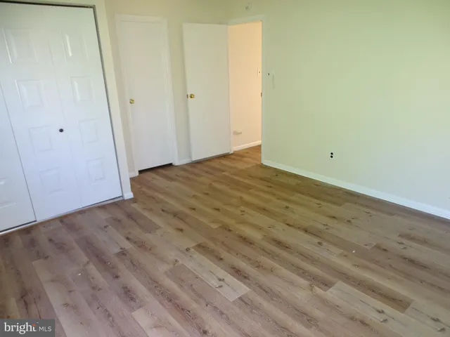 a view of a room with wooden floor