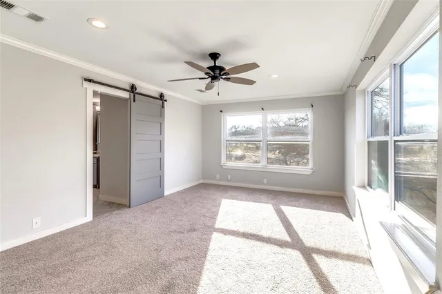 a view of a livingroom with a ceiling fan and window