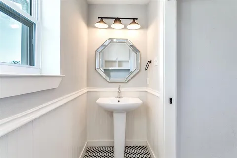 a bathroom with a sink a mirror and a vanity