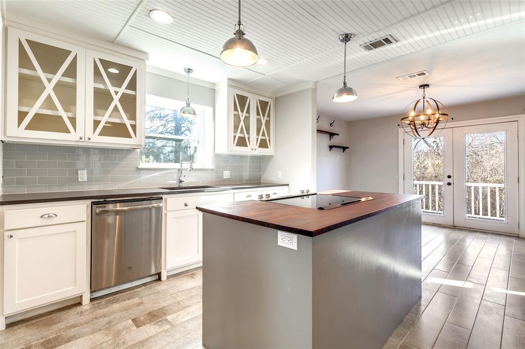 438 Lost Lane Midlothian, TX 76065 - Photo 5 of 33 a kitchen with kitchen island granite countertop a sink cabinets and a large window