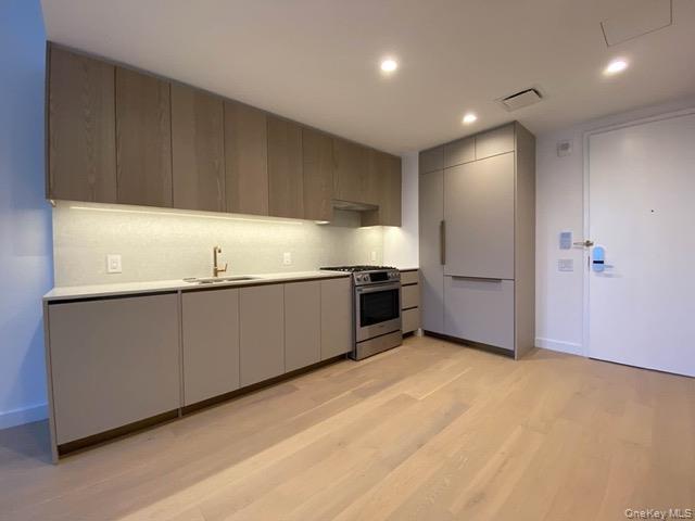 3 Court Square, Unit 614 Queens, NY 11101 - Photo 3 of 7 a kitchen with cabinets and window