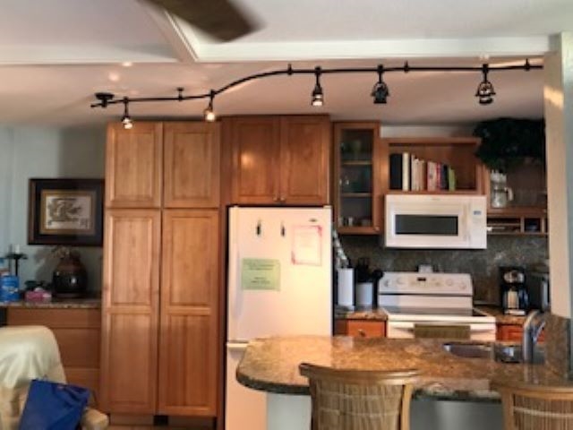 a kitchen with stainless steel appliances granite countertop a refrigerator and a stove