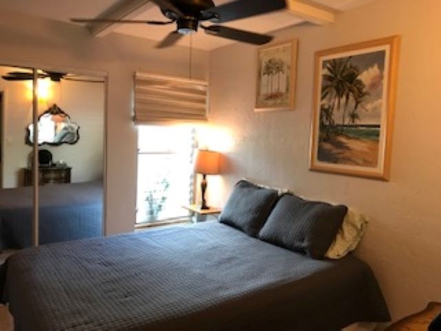 2037 South Kihei Road, Unit 1 Kihei, HI 96753 - Photo 15 of 16 a bedroom with a bed and a lamp