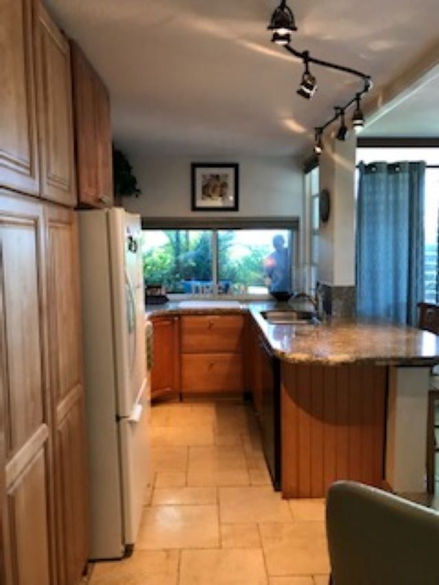 2037 South Kihei Road, Unit 1 Kihei, HI 96753 - Photo 3 of 16 a kitchen with stainless steel appliances granite countertop a refrigerator and a sink