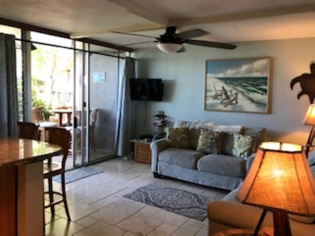 2037 South Kihei Road, Unit 1 Kihei, HI 96753 - Photo 6 of 16 a living room with furniture and a flat screen tv