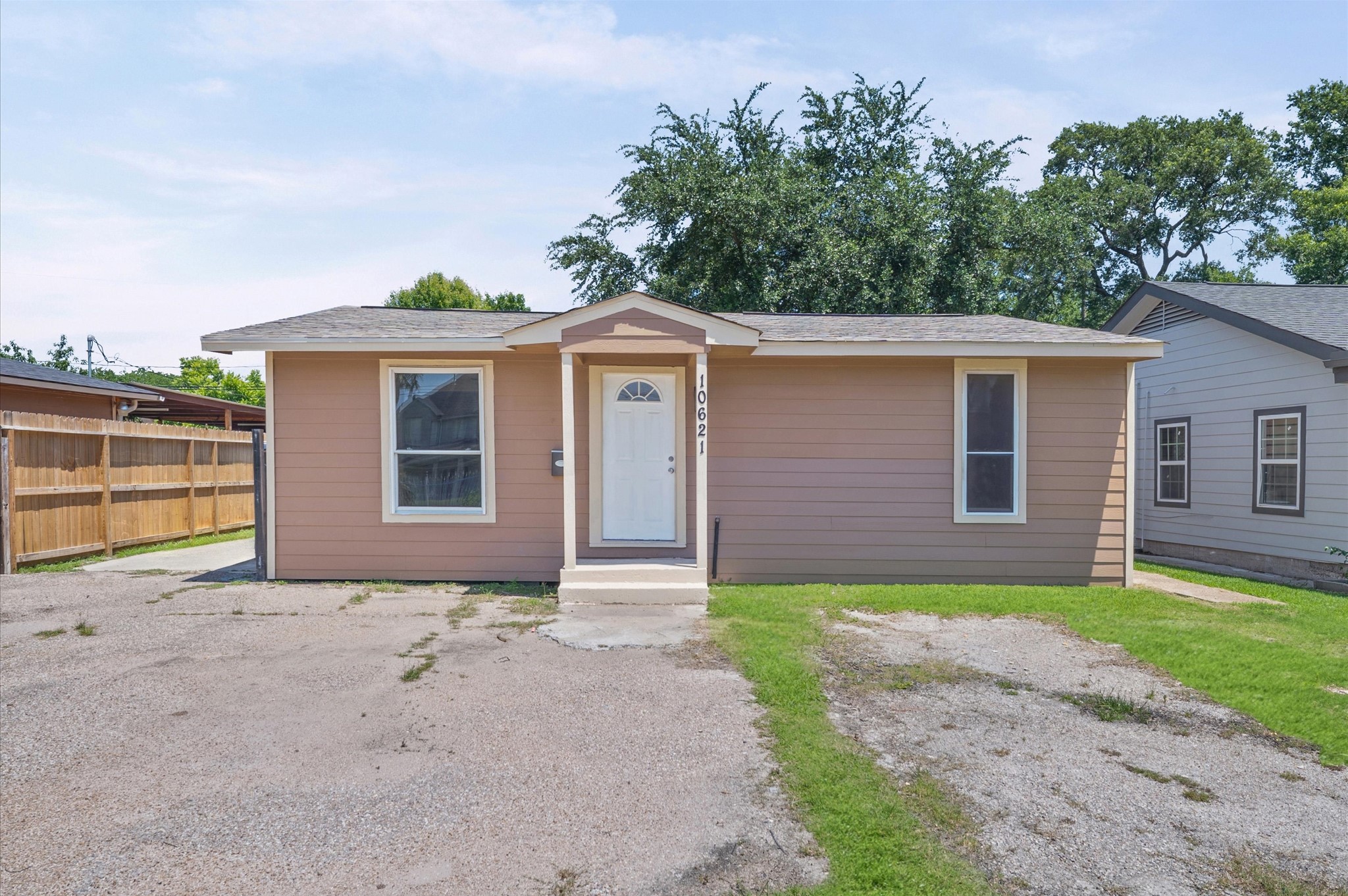 10621 Lane Street Houston, TX 77029 - Photo 1 of 29 a front view of a house with a garden and yard