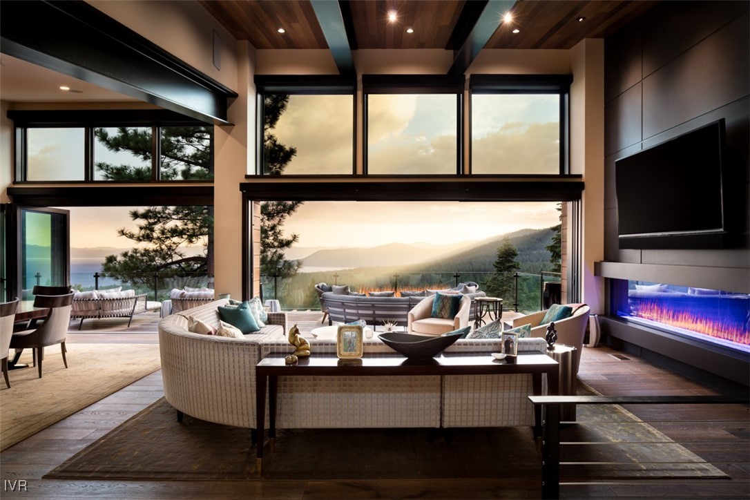 a living room with furniture tv and large window