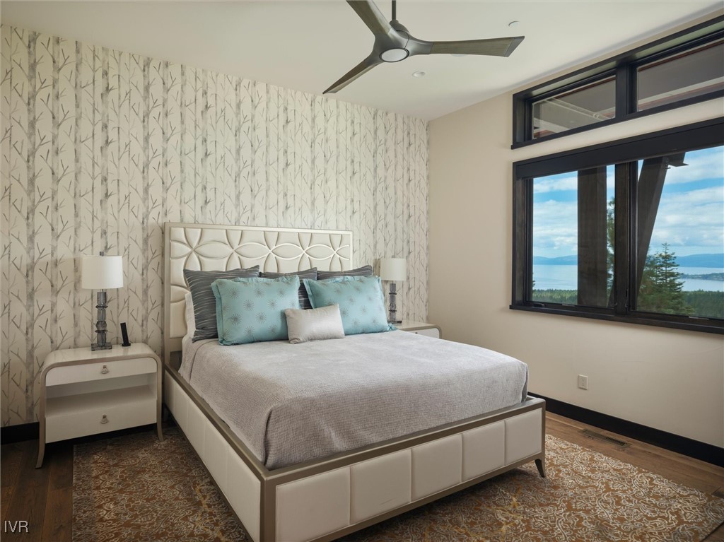 575 Fairview Boulevard Incline Village, NV 89451 - Photo 33 of 40 a bedroom with a bed lamp and a large window