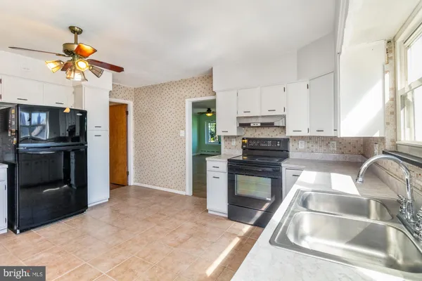 a kitchen with stainless steel appliances granite countertop a stove a refrigerator and a sink