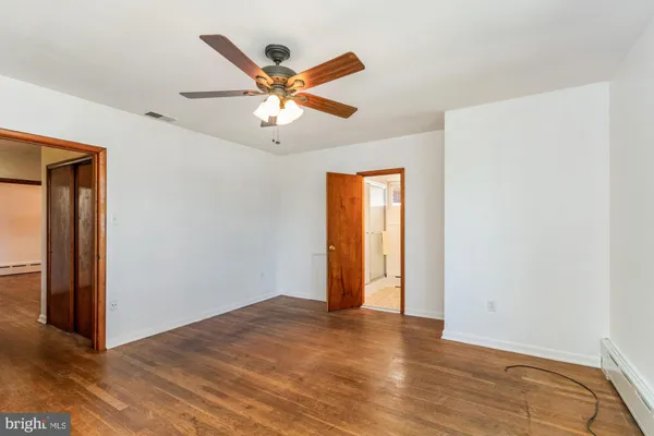 a view of a livingroom with a ceiling fan and window