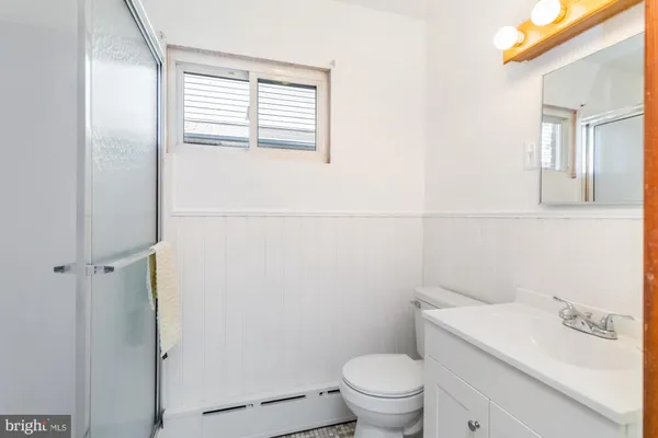 a white toilet sitting next to a bathroom sink