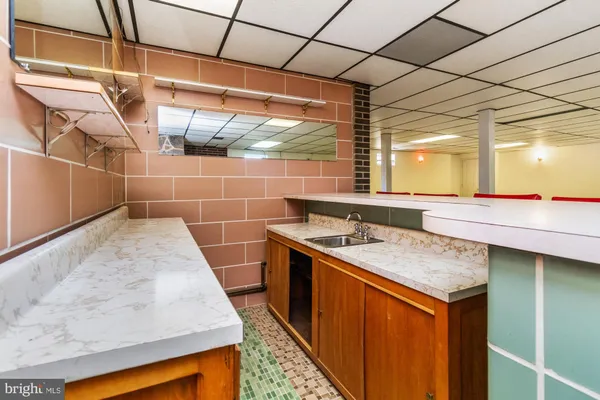 a bathroom with a sink and mirror