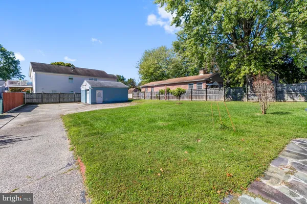 a view of a house with a yard and sitting area