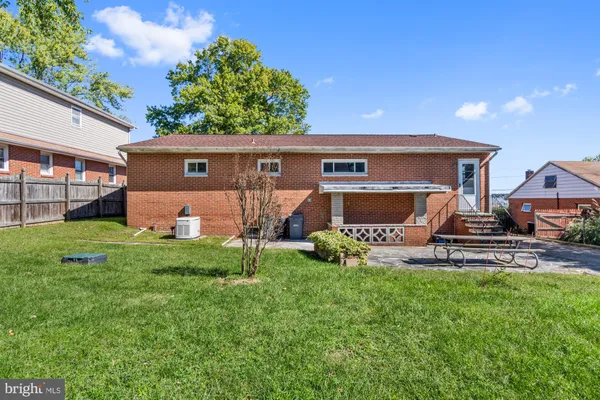 a view of a house with a yard and sitting area