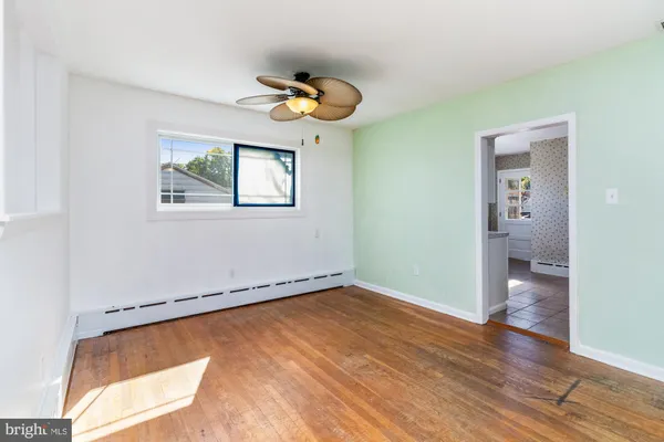 an empty room with a piano and wooden floor