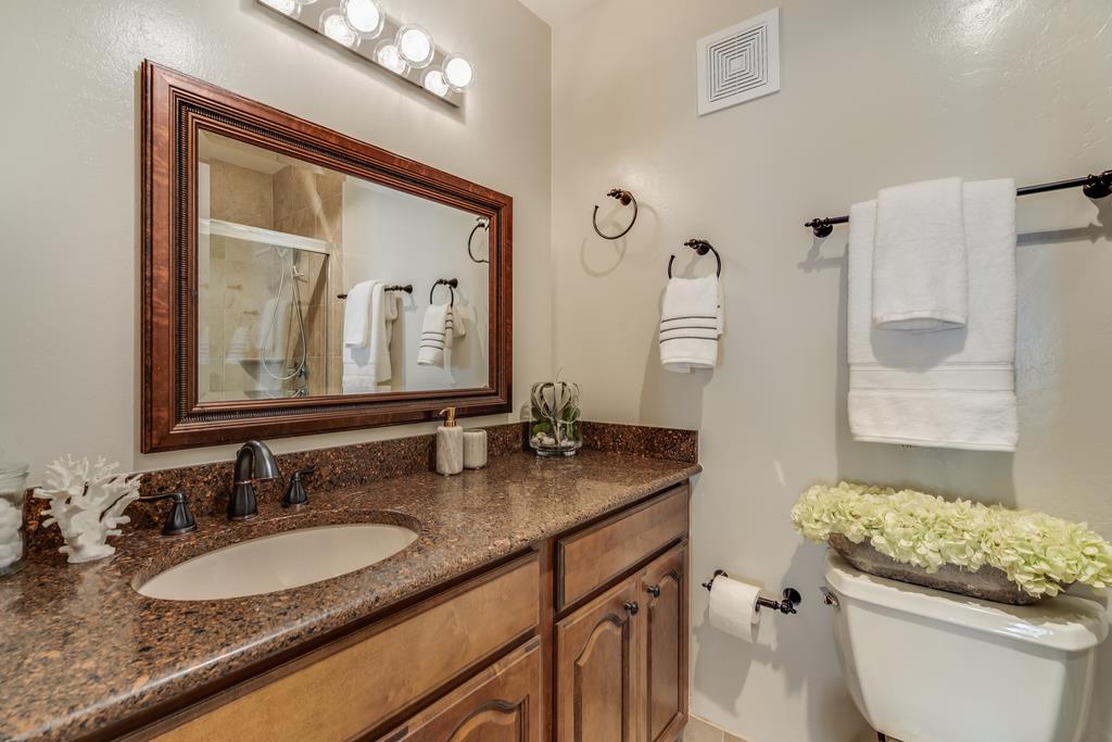 1091 Shell Boulevard, Unit 1 Foster City, CA 94404 - Photo 11 of 20 a bathroom with a granite countertop sink vanity mirror and toilet