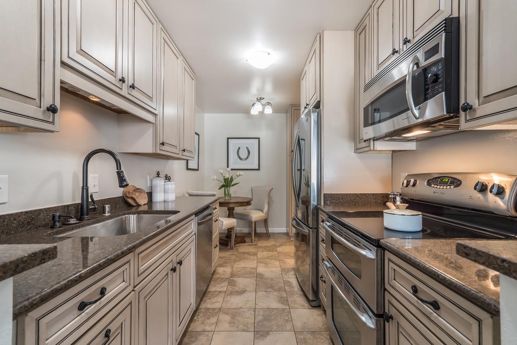 1091 Shell Boulevard, Unit 1 Foster City, CA 94404 - Photo 4 of 20 a kitchen with stainless steel appliances granite countertop a sink and cabinets