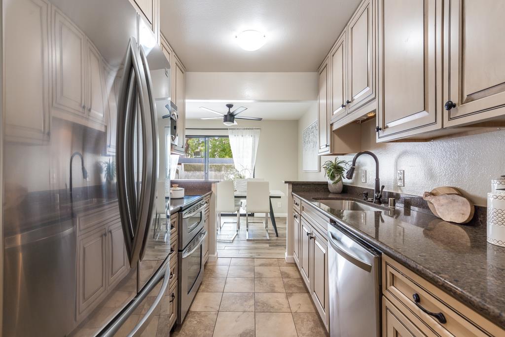 1091 Shell Boulevard, Unit 1 Foster City, CA 94404 - Photo 5 of 20 a kitchen with granite countertop a refrigerator and a sink