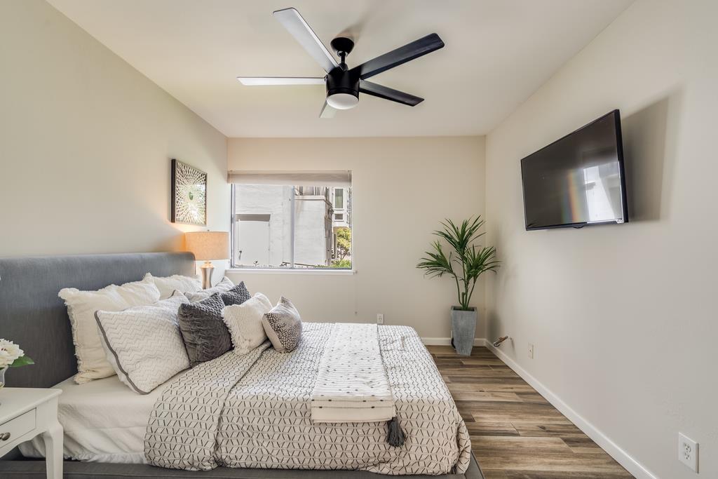 1091 Shell Boulevard, Unit 1 Foster City, CA 94404 - Photo 7 of 20 a bedroom with a bed and a flat screen tv