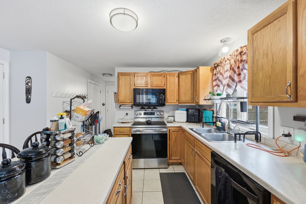 44 Border Street Springfield, MA 01104 - Photo 16 of 36 a kitchen with a sink stove and cabinets