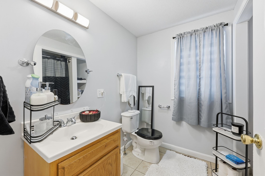 44 Border Street Springfield, MA 01104 - Photo 19 of 36 a bathroom with a sink a toilet and mirror