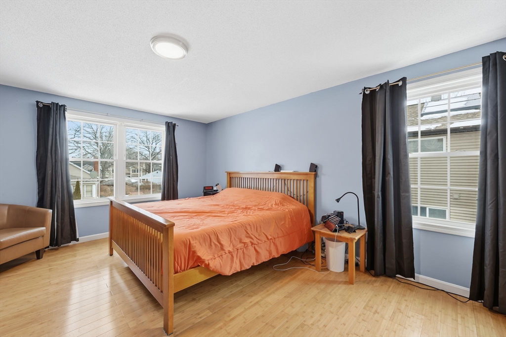 44 Border Street Springfield, MA 01104 - Photo 21 of 36 a bedroom with a bed and a chair