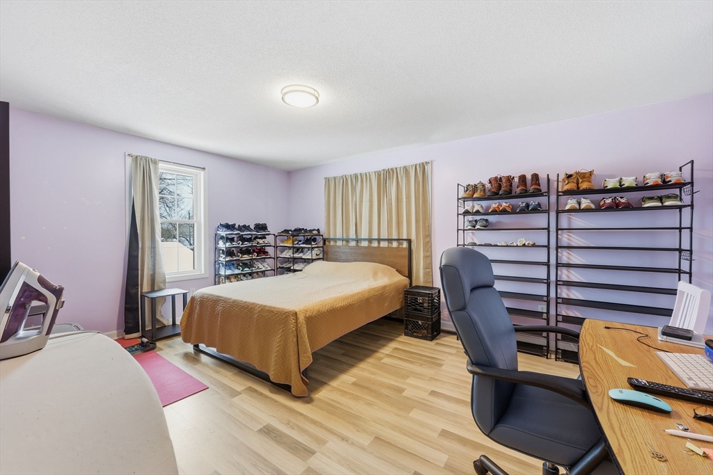 44 Border Street Springfield, MA 01104 - Photo 26 of 36 a bedroom with a bed a books bucket with a desk and chair