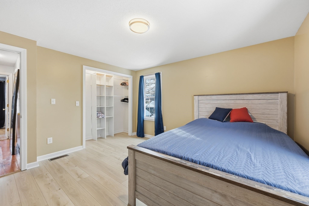 44 Border Street Springfield, MA 01104 - Photo 29 of 36 a bedroom with a large bed and a dresser