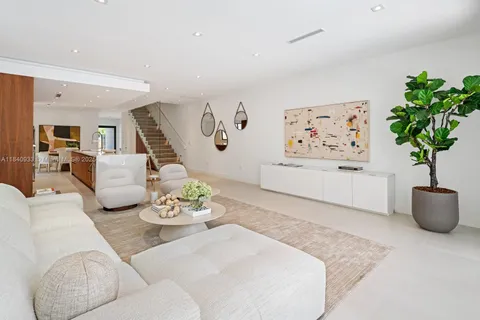 a living room with furniture potted plant and a couch