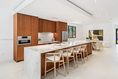 a large kitchen with a table and chairs