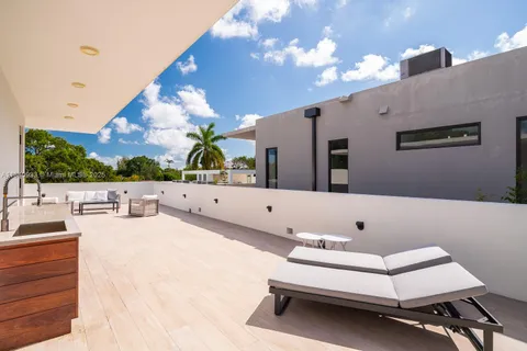 a view of hall way with furniture and chandelier