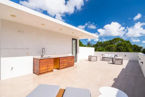 a view of a kitchen with a sink and living room