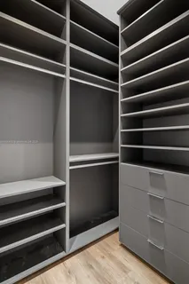 a view of walk in closet with empty racks