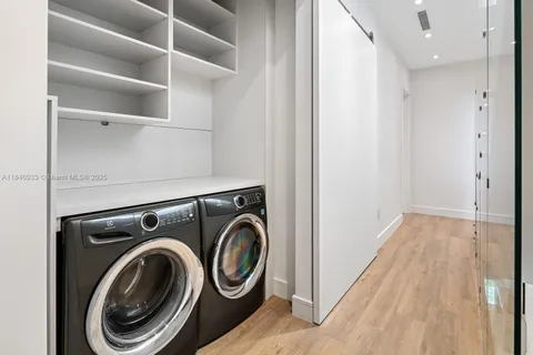 a view of storage and utility room with washer and dryer