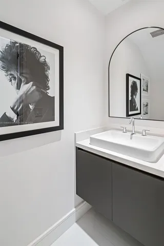 a bathroom with a sink and mirror