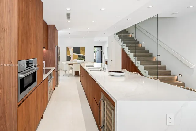 a kitchen with counter top space stainless steel appliances and wooden floor