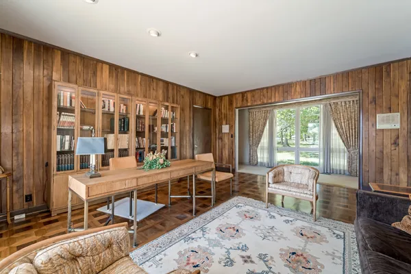 a living room with furniture and large windows