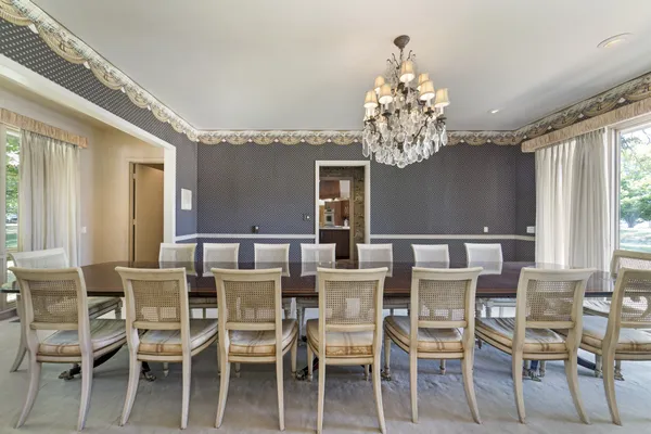 a view of a dining room with furniture and chandelier
